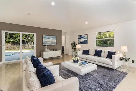 an empty room with wooden floor and window