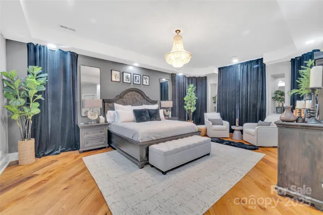 a bedroom with a bed lamps and table