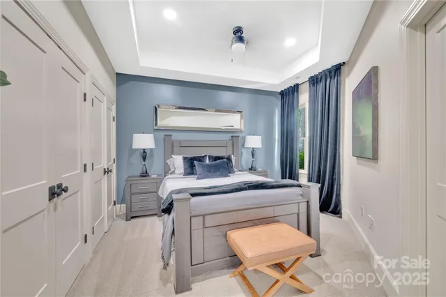 a bedroom with a bed and a chandelier