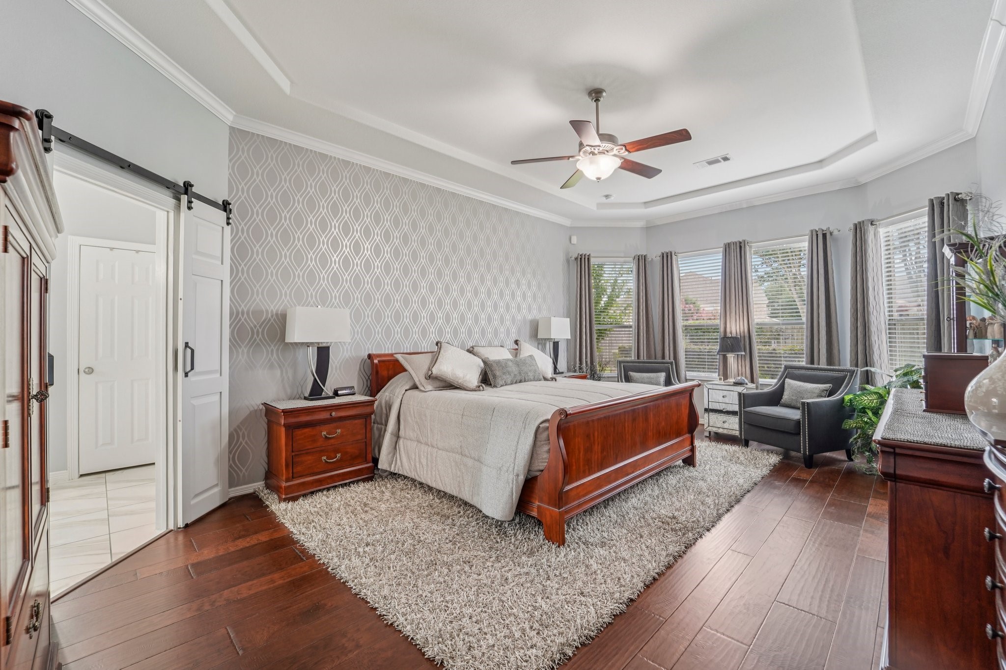 3511 Winding Point Lane Katy, TX 77494 - Photo 16 of 35 a spacious bedroom with a bed couch and a window