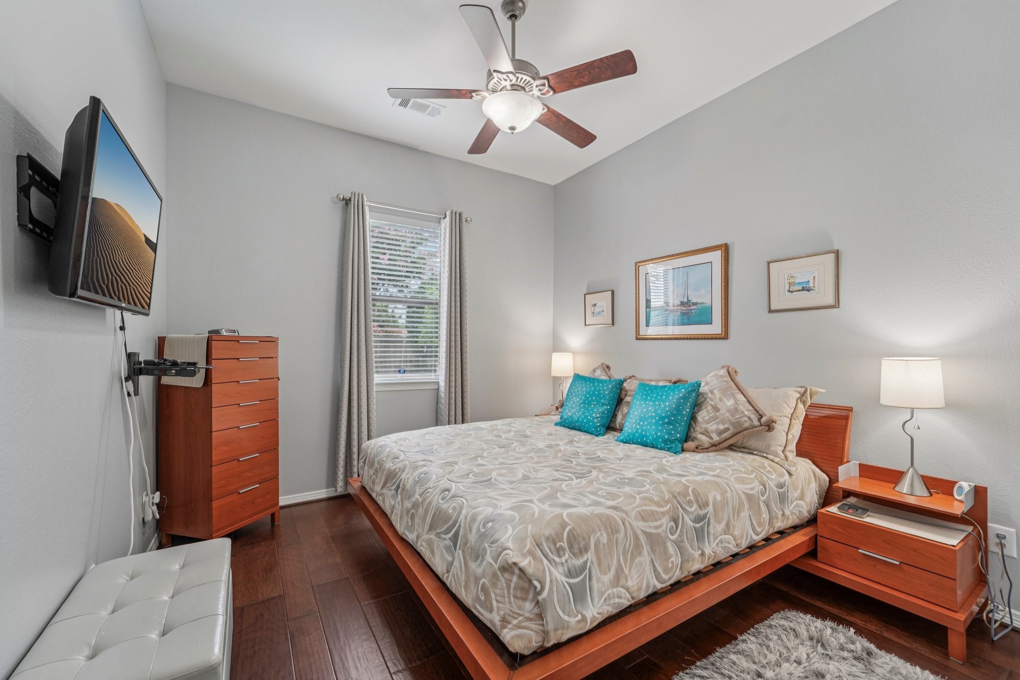 3511 Winding Point Lane Katy, TX 77494 - Photo 24 of 35 a bedroom with a bed a flat screen tv and a chandelier