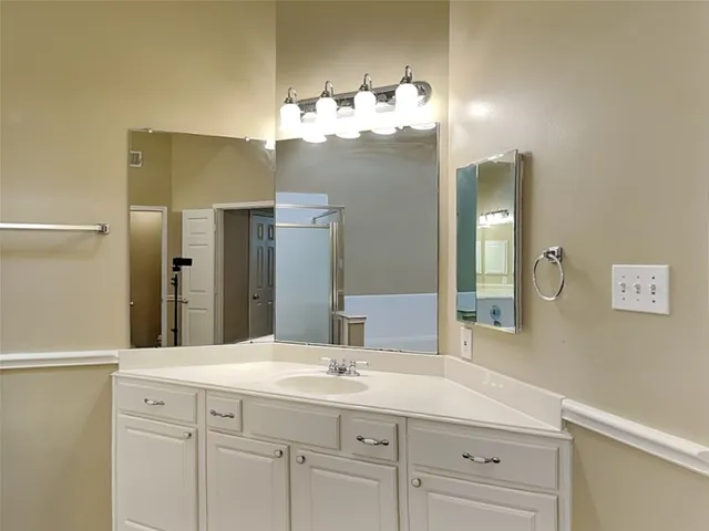 a bathroom with a sink vanity and a mirror