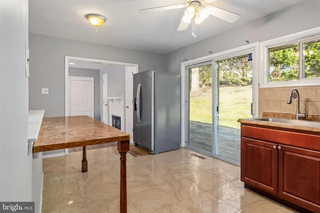 a kitchen with stainless steel appliances granite countertop a sink and a refrigerator