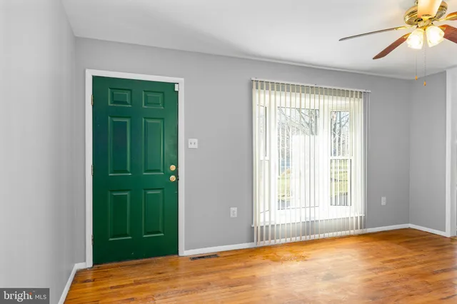 a view of a bedroom with a bed and a window