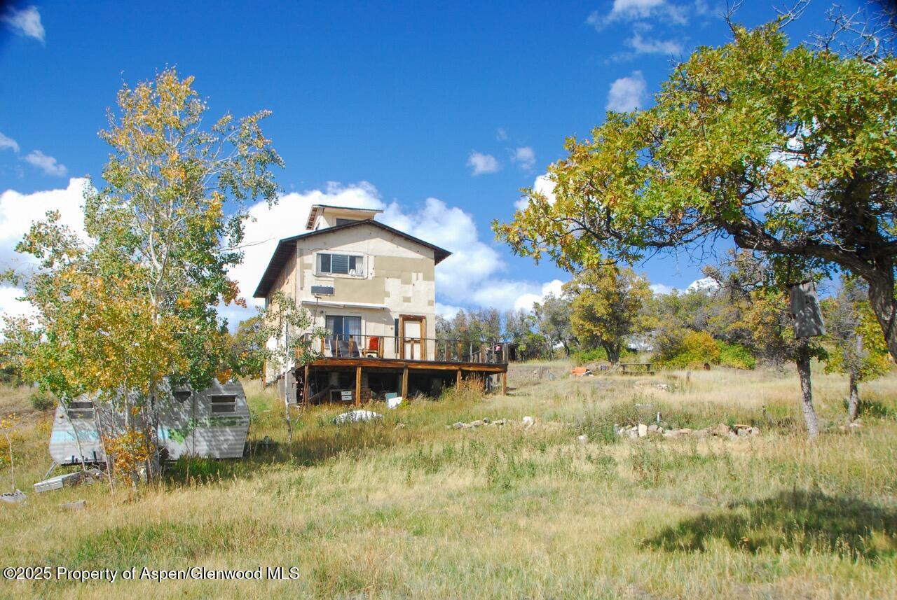 510 South Fork Road Rifle, CO 81650 - Photo 13 of 13 a view of a house with a yard and a large tree