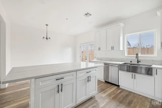 a kitchen with sink and cabinets