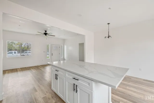 an empty room with wooden floor and window