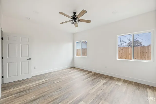 a view of a livingroom with a ceiling fan and window
