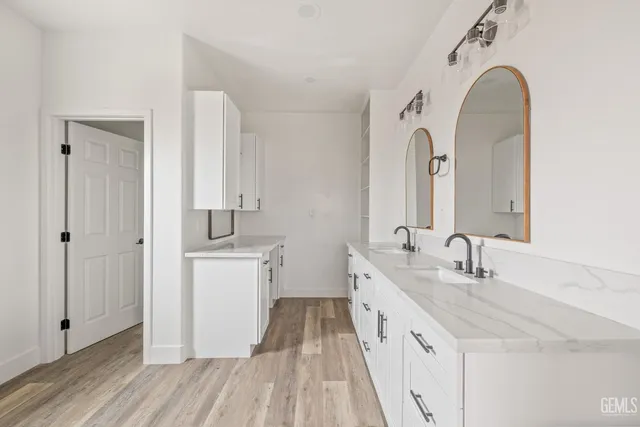 a bathroom with a double vanity sink and a mirror
