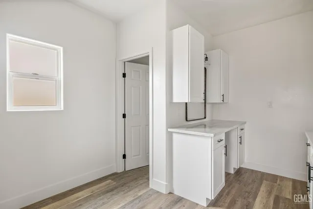 a view of bathroom with a sink mirror and window