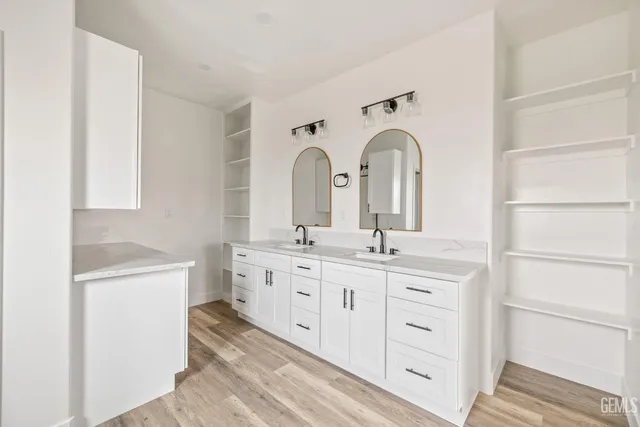 a bathroom with a double vanity sink and a mirror