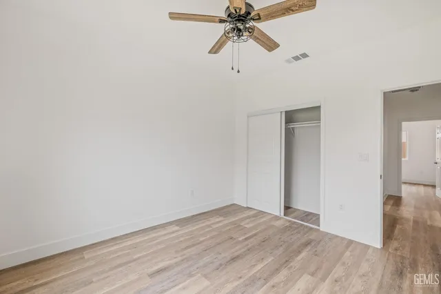 a view of a room with wooden floor