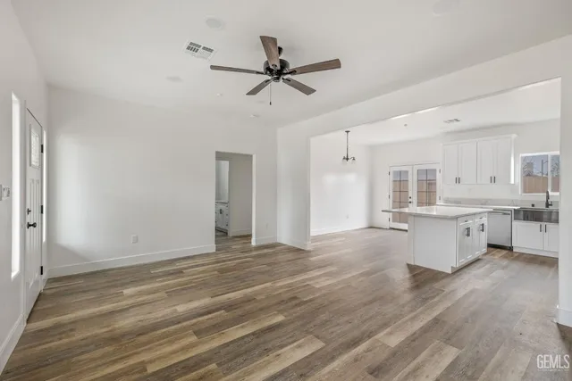 a view of a kitchen with wooden floor and a sink