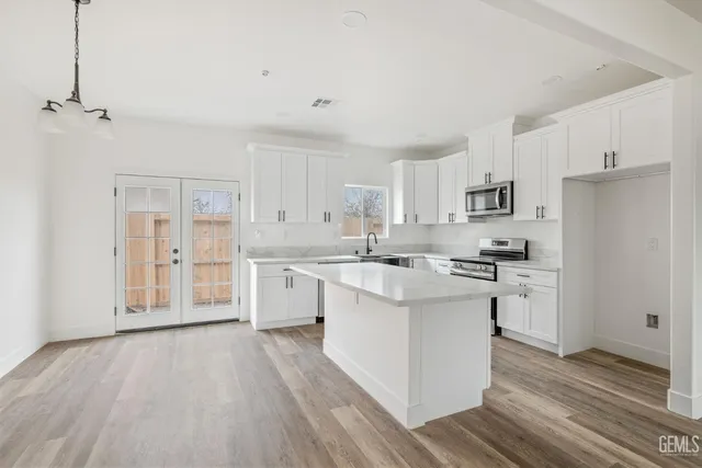 a kitchen with white cabinets and white appliances