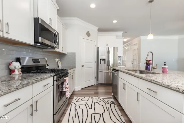 a view of a dining room with furniture and chandelier