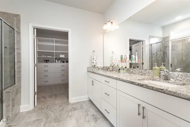 a bedroom with a bed and a ceiling fan