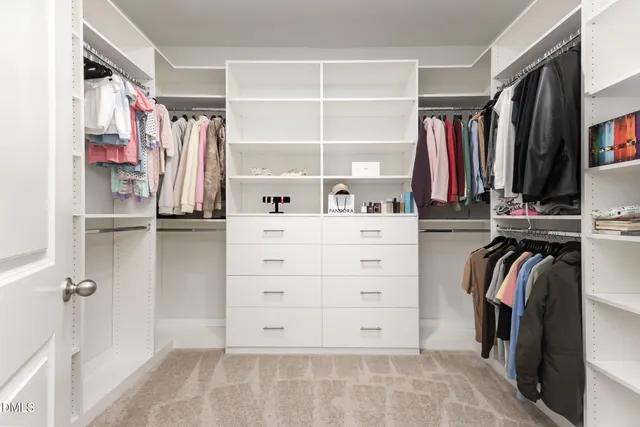 a bedroom with a large bed and a flat screen tv