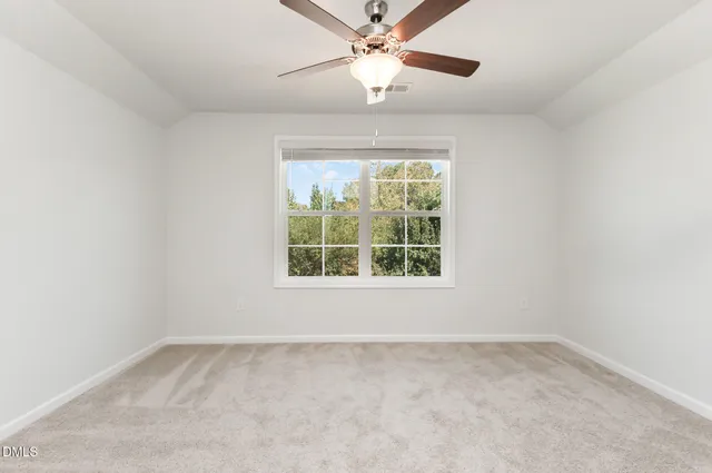 a living room with furniture and a ceiling fan