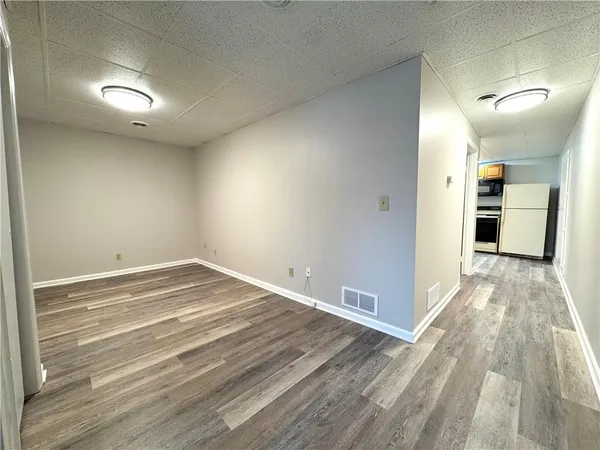 a view of a room with wooden floor
