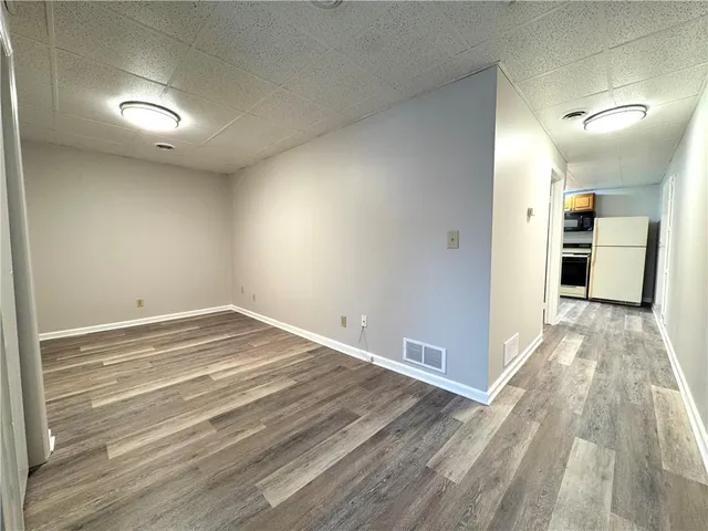 a view of a room with wooden floor