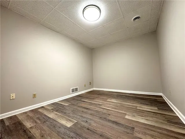 a view of room with wooden floor and fan