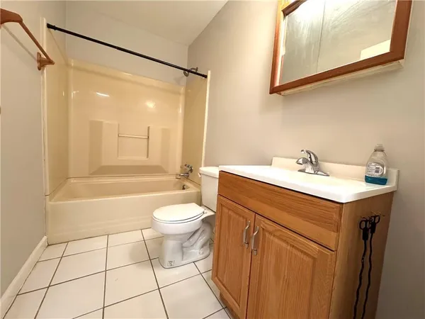 a bathroom with a sink mirror vanity and toilet