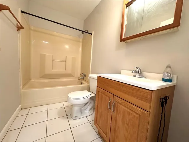a bathroom with a sink mirror vanity and toilet