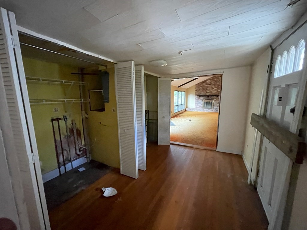 65 Beacon Street Melrose, MA 02176 - Photo 6 of 13 a view of a hallway to a livingroom with furniture wooden floor and window