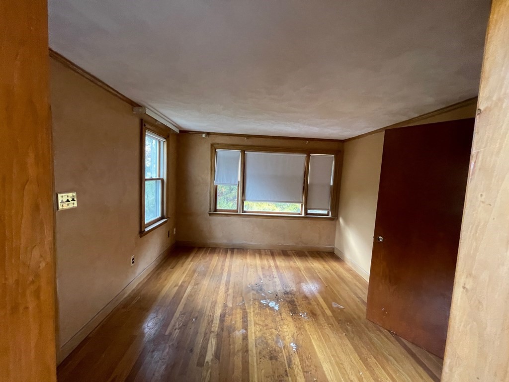 65 Beacon Street Melrose, MA 02176 - Photo 8 of 13 a view of an empty room with wooden floor and a window