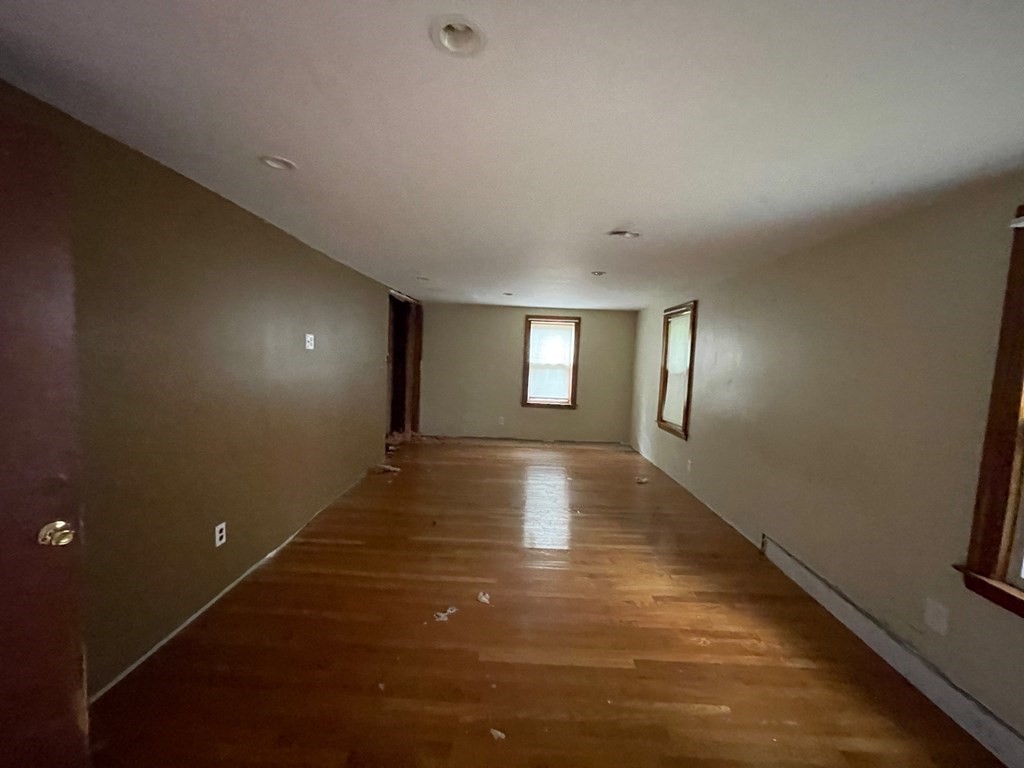 65 Beacon Street Melrose, MA 02176 - Photo 10 of 13 an empty room with wooden floor and windows