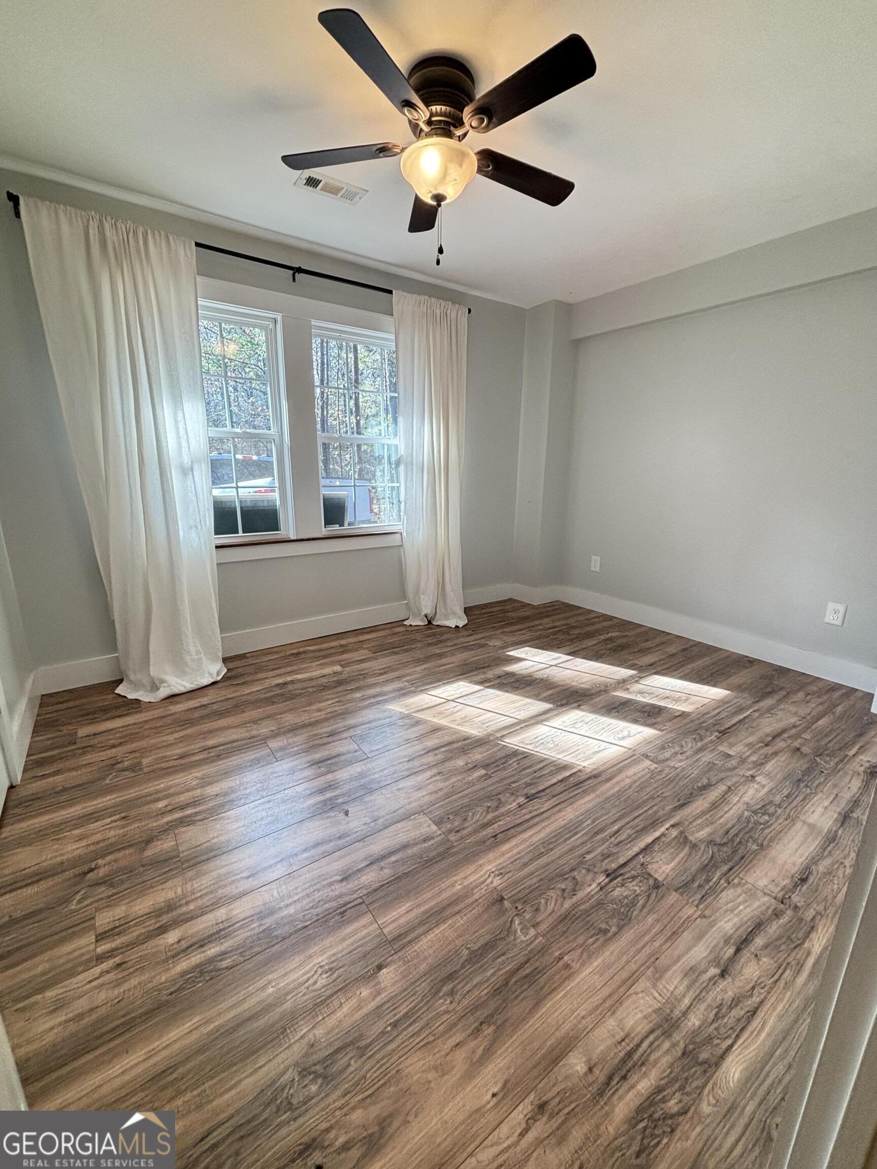 14 Emory Street Newnan, GA 30265 - Photo 13 of 27 a view of an empty room with wooden floor and a window