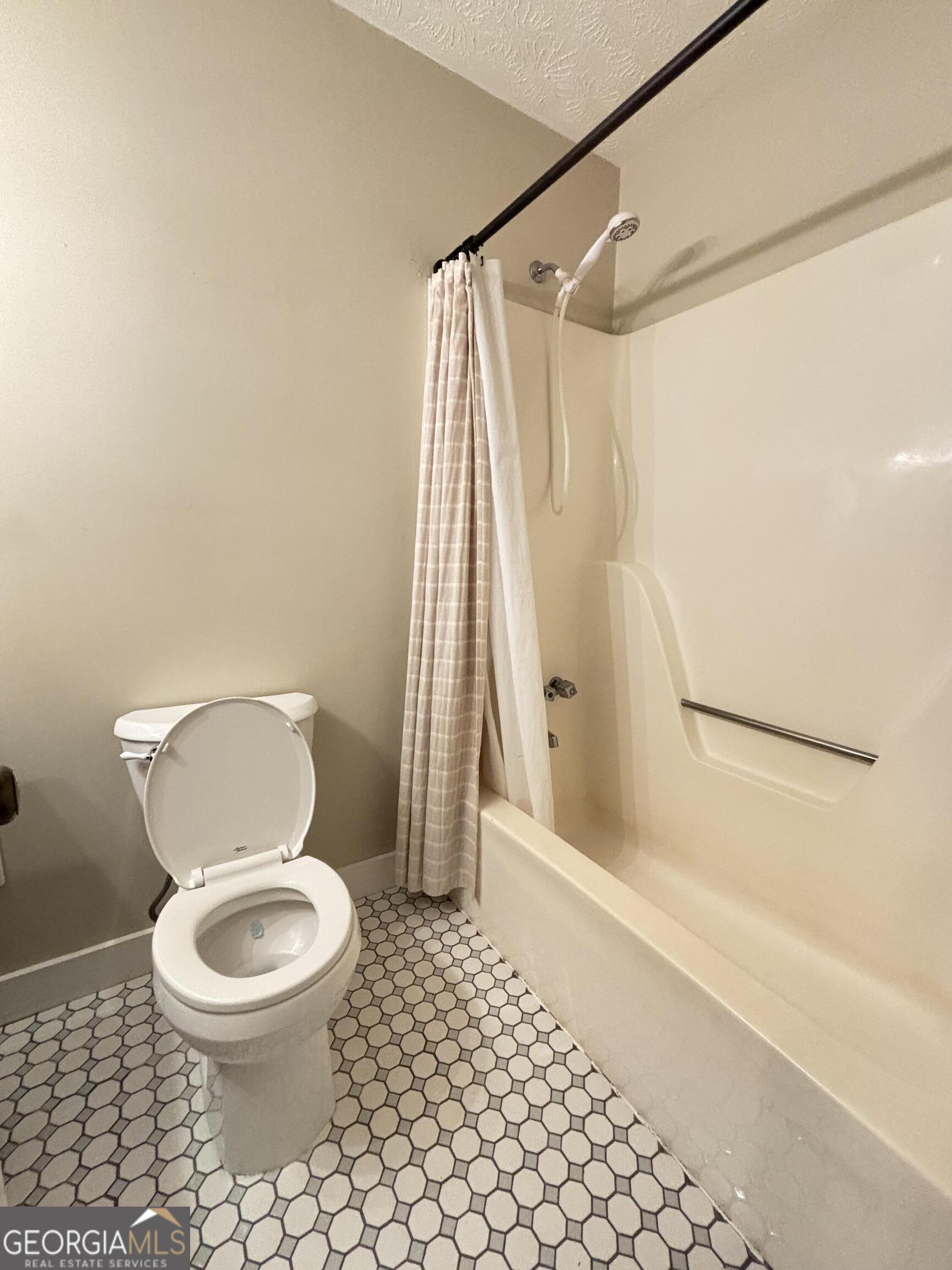 14 Emory Street Newnan, GA 30265 - Photo 14 of 27 a bathroom with a toilet and a shower