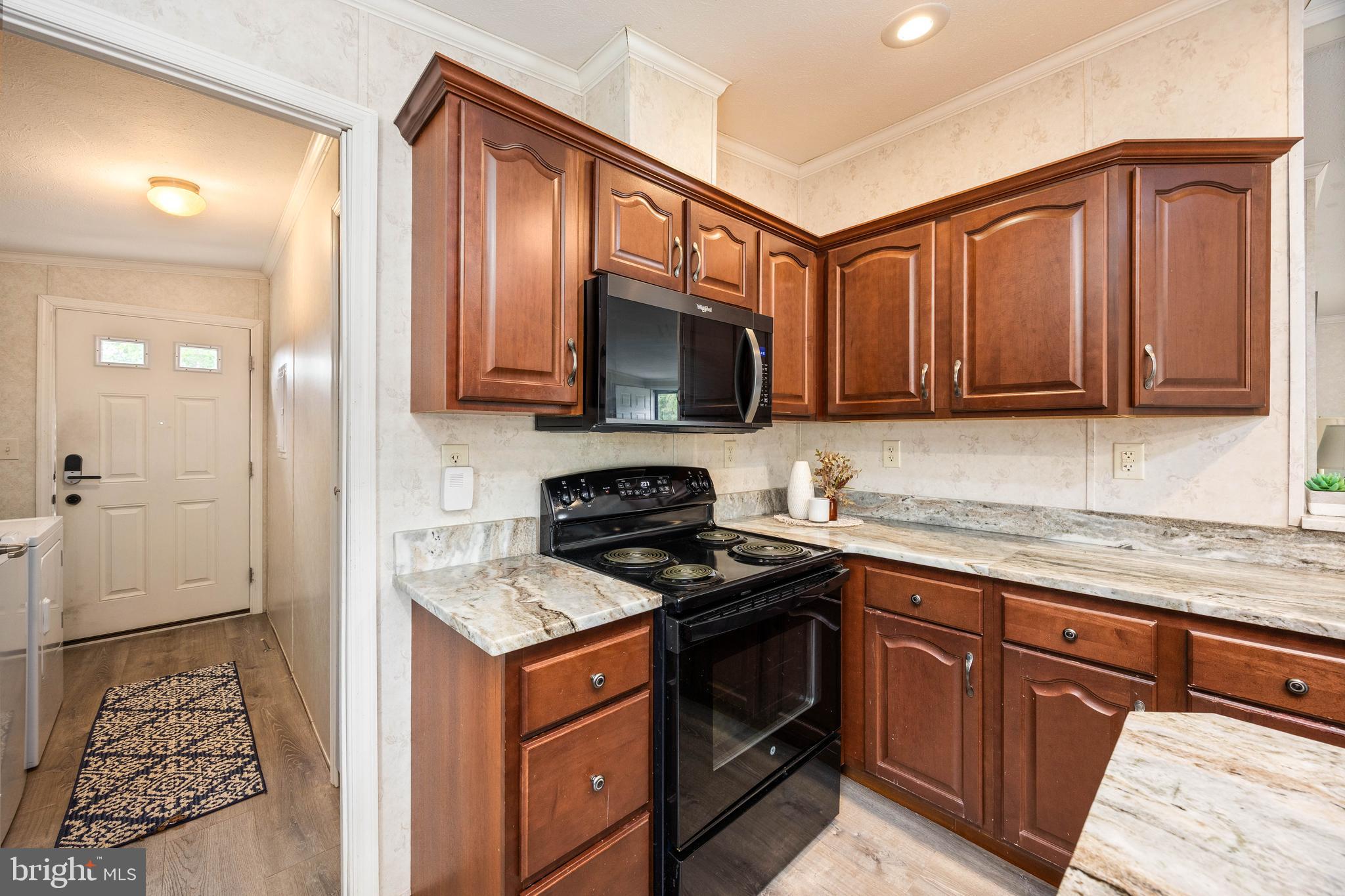 4258 Smith Road Salisbury, MD 21801 - Photo 25 of 43 a kitchen with granite countertop wooden cabinets and a stove top oven