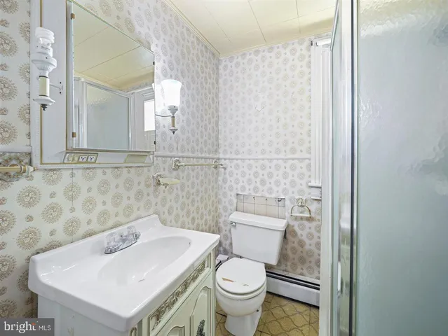 a bathroom with a sink a toilet and mirror