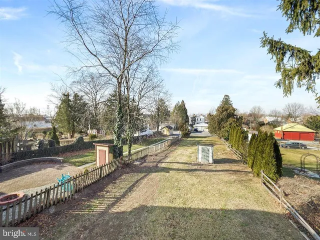 a view of a yard with swimming pool and trees