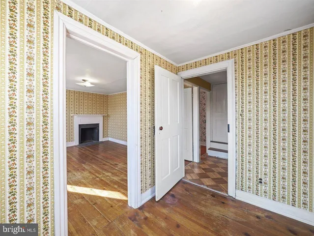 a view of a livingroom with wooden floor and staircase