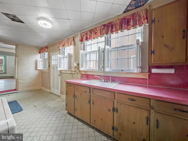 a bathroom with a sink mirror and a shower