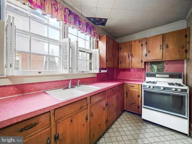 a kitchen with stainless steel appliances granite countertop a sink and a stove