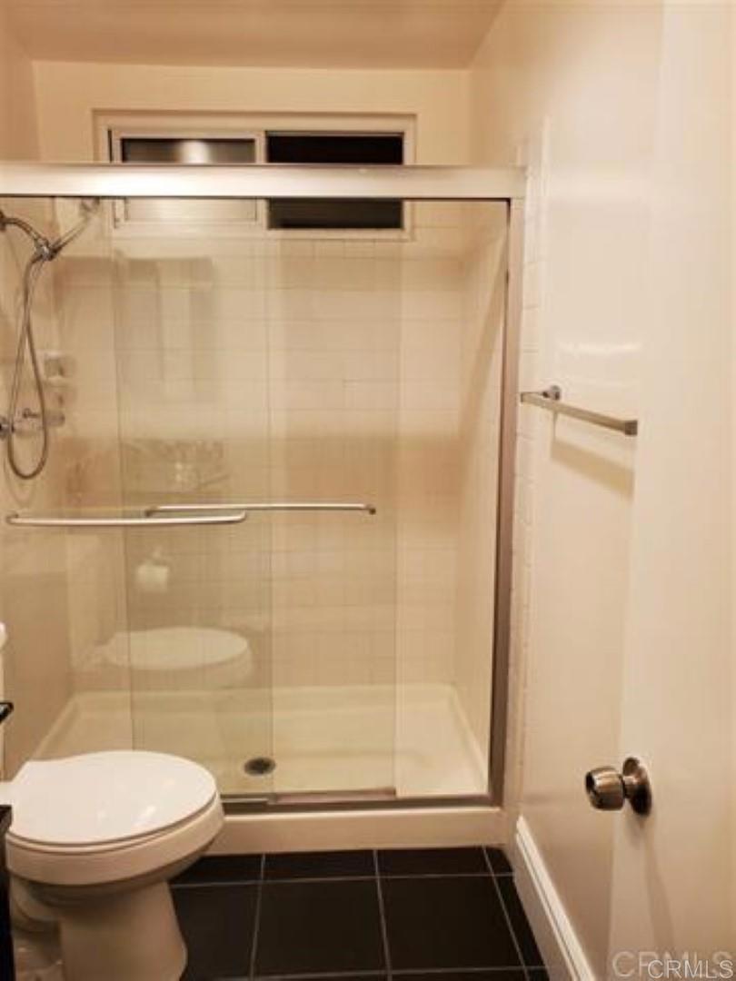 6701 Paseo Del Norte, Unit E Carlsbad, CA 92011 - Photo 11 of 23 a bathroom with a shower and a toilet
