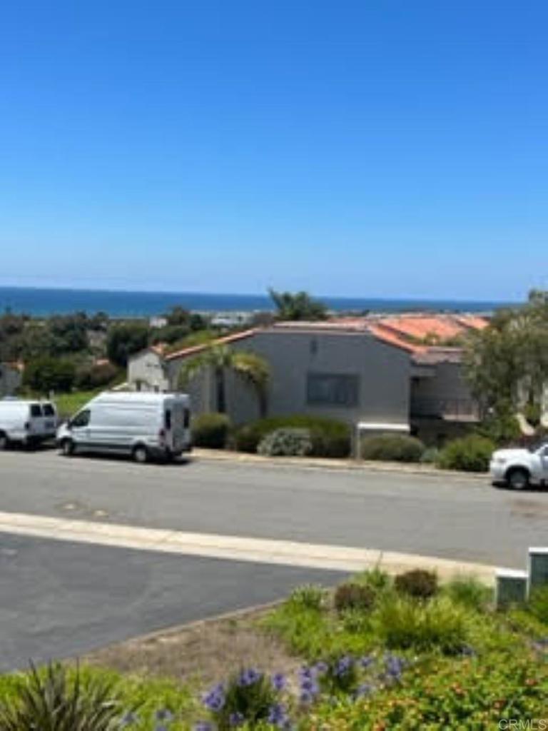 6701 Paseo Del Norte, Unit E Carlsbad, CA 92011 - Photo 18 of 23 a view of a parking area and a car parked