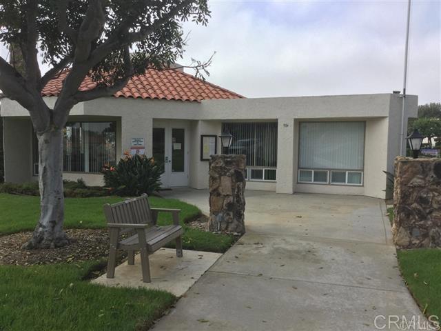 6701 Paseo Del Norte, Unit E Carlsbad, CA 92011 - Photo 21 of 23 a front view of a house with garden