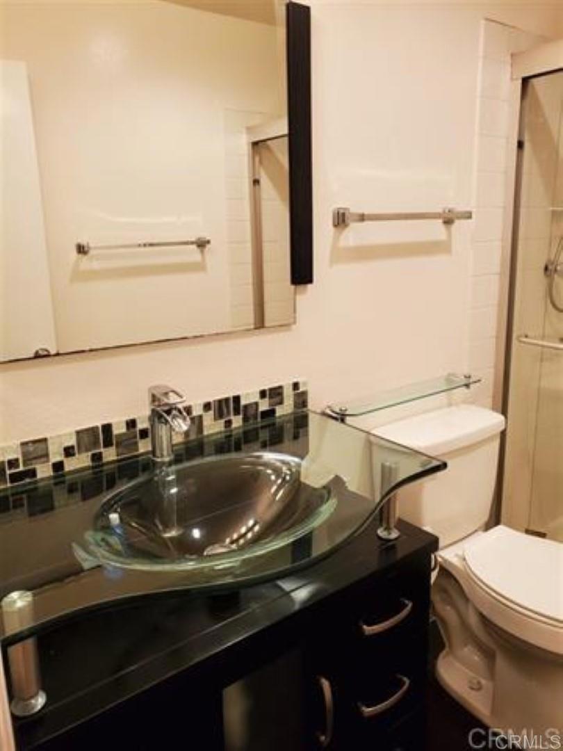 6701 Paseo Del Norte, Unit E Carlsbad, CA 92011 - Photo 10 of 23 a bathroom with a sink and a toilet