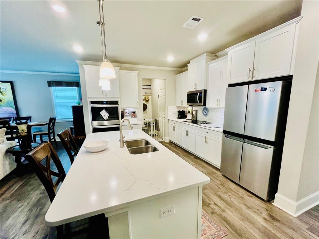 3015 Winding Ridge Waleska, GA 30183 - Photo 7 of 40 a kitchen with white cabinets and refrigerator