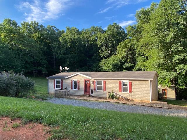 208 Board Mountain Road Goodview, VA 24095 - Photo 1 of 11 a front view of a house with a yard