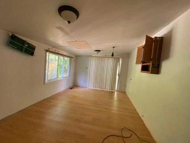 208 Board Mountain Road Goodview, VA 24095 - Photo 8 of 11 a view of a livingroom with wooden floor and windows