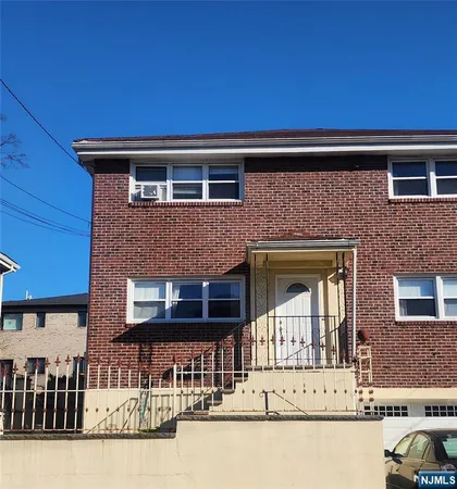 a front view of a house with large windows