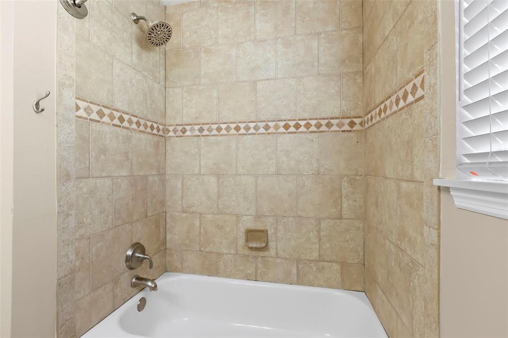 708 Sunset Cove Madeira Beach, FL 33708 - Photo 28 of 61 a bathroom with a bathtub and shower