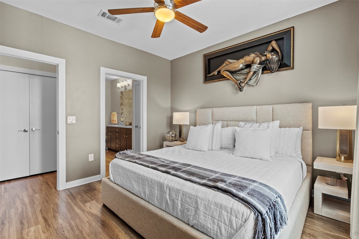 1900 Barton Springs Road, Unit 5027 Austin, TX 78704 - Photo 11 of 28 a bedroom with a large bed and a chandelier
