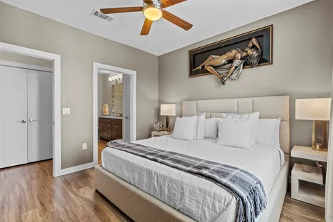 a bedroom with a large bed and a chandelier