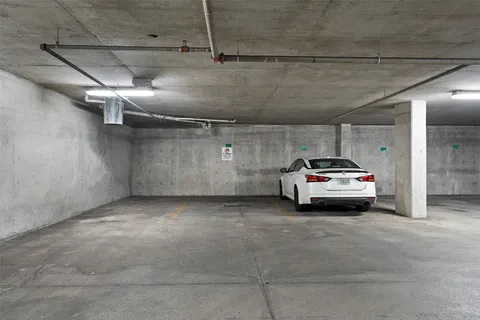 a view of parking garage with cars